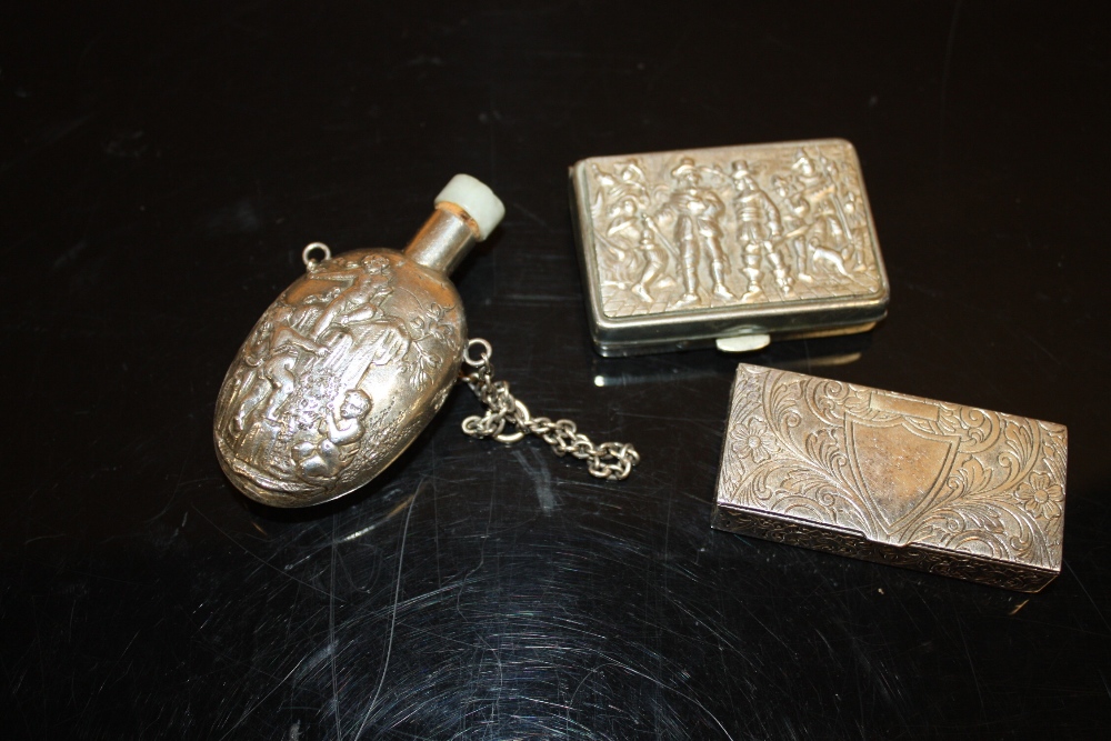 A CHERUBIC WHITE METAL SNUFF BOTTLE WITH JADE TYPE STOPPER, TOGETHER WITH A WHITE METAL SNUFF BOX