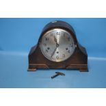 AN OAK MANTEL CLOCK WITH KEY