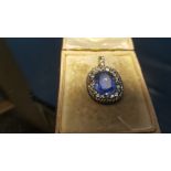 A VICTORIAN STYLE LARGE SAPPHIRE AND DIAMOND PENDANT, the central oval sapphire is approx. 15 mm x