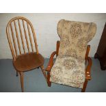 A WOODEN RECLINER CHAIR AND AN ERCOL STYLE STICK BACK CHAIR