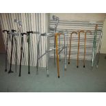 A COLLECTION OF WALKING AIDS TO INCLUDE AN ALUMINIUM FOLDING ZIMMER FRAME AND SEVERAL QUALITY