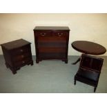 A SELECTION OF FOUR ITEMS TO INCLUDE A SERPENTINE THREE DRAWER CHEST, A BOOKSHELF, AN OVAL TABLE AND