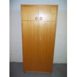 A MODERN SCHREIBER MAN'S TWO DOOR WARDROBE WITH TOP BOX ON CASTORS