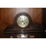 AN OAK MANTEL CLOCK