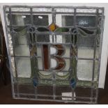 A FRAMED GLASS WINDOW, APPROX. 74 X 66 CM