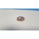 A 9 CT GOLD AMETHYST AND SEED PEARL GALLERY MOUNTED BROOCH. Approx. weight 3.1 g, width 2.5 cm
