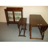 A LEADED DISPLAY UNIT, A SMALL TWIST TOP DROP LEAF OAK TABLE AND AN OVAL OAK LARGER DROP LEAF DINING