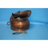 A COPPER COAL SCUTTLE TOGETHER WITH A PAIR OF TONGS