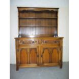 A MEDIUM OAK DISPLAY WALL UNIT WITH CARVED DETAILING, WIDTH 126 CM