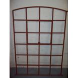 A CAST IRON ARCHED WINDOW FRAME WITH OPENING LITE EARLY 1900S, HEIGHT 155 CM WIDTH 108 CM