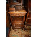 A SMALL OAK CARVED POT CUPBOARD W - 40 CM