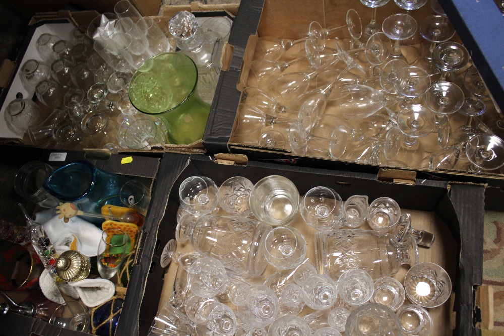 FOUR TRAYS OF ASSORTED GLASSWARE TO INCLUDE DECANTERS, BOXED TUTBURY CRYSTAL CAKE KNIFE ETC.