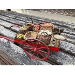 A RARE EARLY 20TH CENTURY PAINTED TINPLATE TOY GROCERS CART, with miniature woven baskets,some