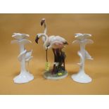 A CERAMIC FLAMINGO FIGURE GROUP, TOGETHER WITH A PAIR OF FLORAL FLAMINGO SHAPED CANDLESTICKS