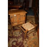 A SMALL GOTHIC OAK POT CUPBOARD AND AN OAK STOOL (2)