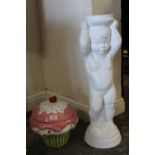 A LARGE CERAMIC CUPCAKE SHAPED LIDDED JAR, ON MATCHED WHITE PAINTED STONE FIGURATIVE PLINTH (2)