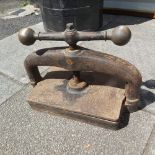 A VICTORIAN INDUSTRIAL CAST IRON BOOK PRESS WITH BRASS TURNING HANDLE