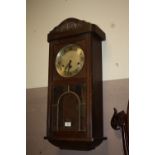 AN EDWARDIAN OAK CASED WALLCLOCK