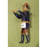 A VINTAGE TIN PLATE WIND-UP FIGURE - POSSIBLY A FIREMAN