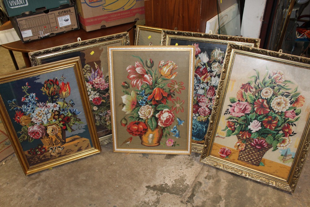 A COLLECTION OF GILT FRAMED AND GLAZED NEEDLEWORKS OF FLOWERS IN VASES (6)