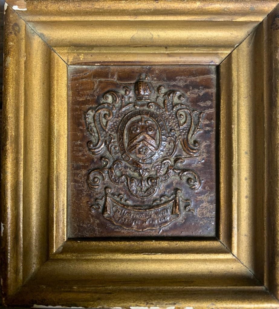 A 19TH CENTURY LEATHER MINIATURE PANEL, embossed with a coat of arms below a Papal crown with script
