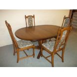 AN ERCOL DINING SET WITH FOUR CHAIRS AND EXTENDING TABLE