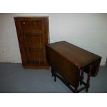 A CHINA DISPLAY CABINET AND A DROP LEAF OAK TABLE