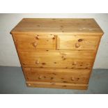 A SOLID PINE TWO OVER TWO CHEST OF DRAWERS