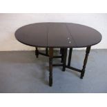 AN OAK DROP LEAF TABLE