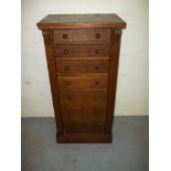 AN OAK NARROW CHEST OF DRAWERS