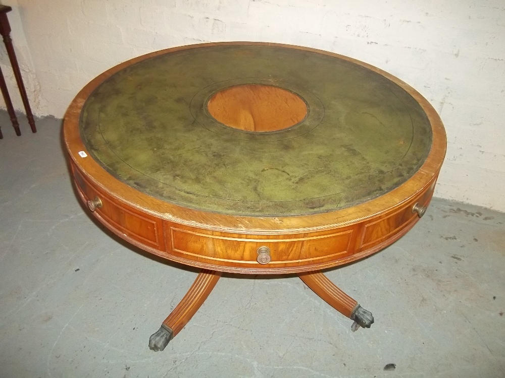 A ROUND LEATHER INLAID TABLE WITH DRAWERS