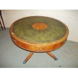 A ROUND LEATHER INLAID TABLE WITH DRAWERS