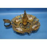 A GILT METAL CANDLE HOLDER WITH CAMEO INSETS AND A CANDLE SNUFFER
