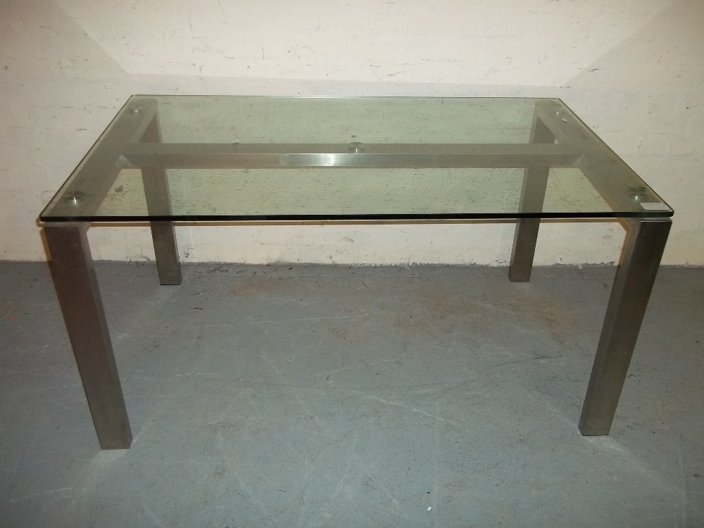 A GLASS TOPPED DINING TABLE