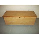 A WOODEN STORAGE BOX CHEST ON WHEELS