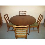 A YEW SINGLE PEDESTAL DINING TABLE AND FOUR SOLID STURDY CHAIRS (MISSING EXTENSION LEAF), G.T.