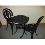 A CAST ALUMINIUM THREE PIECE GARDEN PATIO SET, ONE TABLE AND TWO CHAIRS