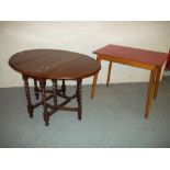 AN ANTIQUE OAK DROP LEAF TABLE AND A FORMICA TOPPED KITCHEN TABLE