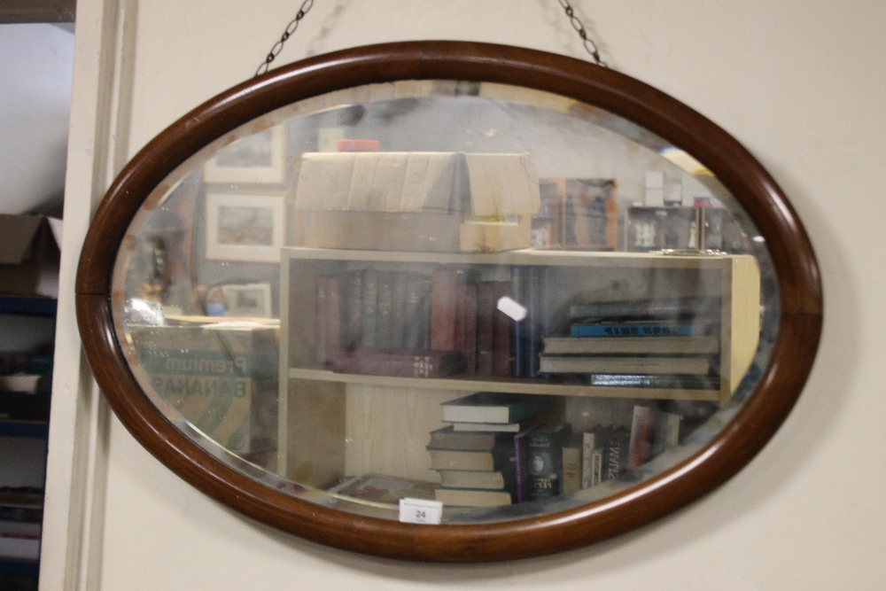 AN OVAL FRAMED MIRROR 64 X 49 CM