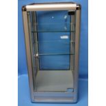 A GLAZED TABLE TOP DISPLAY CABINET WITH FITTED GLASS SHELVES, H 70 CM, W 36 CM D 36 CM