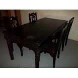 A LARGE EBONISED TYPE BLACK WOOD / CAST IRON DINING SET WITH FOUR CHAIRS, SOME HEAT MARKS TO TOP