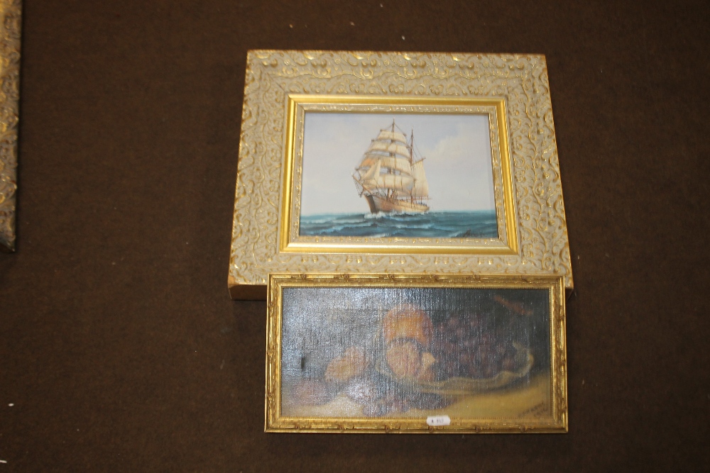 A FRAMED STILL LIFE OIL DEPICTING FRUIT TOGETHER WITH AN OIL PAINTING OF A SHIP