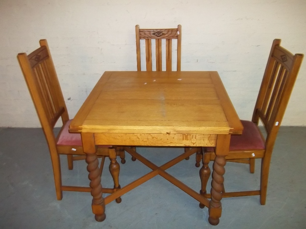 AN OAK DRAWER LEAF TABLE AND THREE CHAIRS