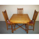 AN OAK DRAWER LEAF TABLE AND THREE CHAIRS