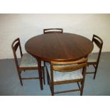 A ROSEWOOD EXTENDING DINING TABLE AND FOUR MATCHED CHAIRS BY McINTOSH