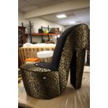 A DESIGNER LEOPARD SKINNED STILETTO STYLE CHAIR