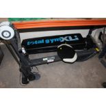 A TOTAL GYM XLI WORKOUT BENCH AND A ROWING MACHINE