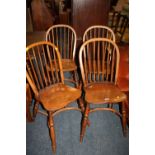 A MODERN SET OF FOUR OAK HOOP BACK CHAIRS