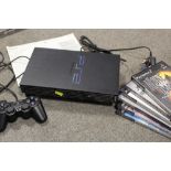 A PS2 CONSOLE AND GAMES CONTROLLER