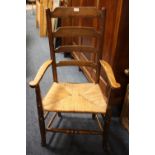 AN OAK WICKERSEAT LADDERBACK ARMCHAIR